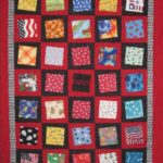 Catch - This quilt was made in memory of a dog named Catch using his doggy scarves