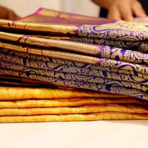 Purple and yellow fabrics stacked on top of each other. 