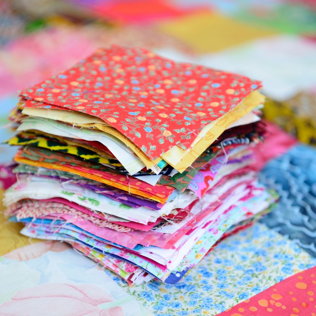 small colorful patches of cloth stacked up
