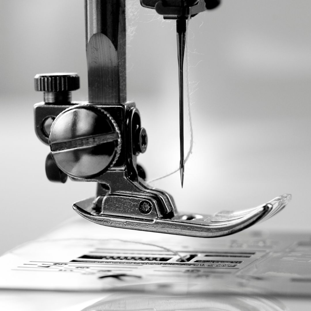 black and white needle and foot on a sewing machine