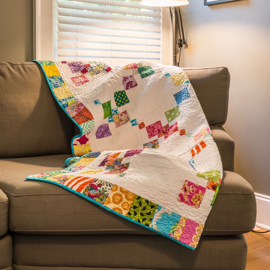 quilt draped over a couch