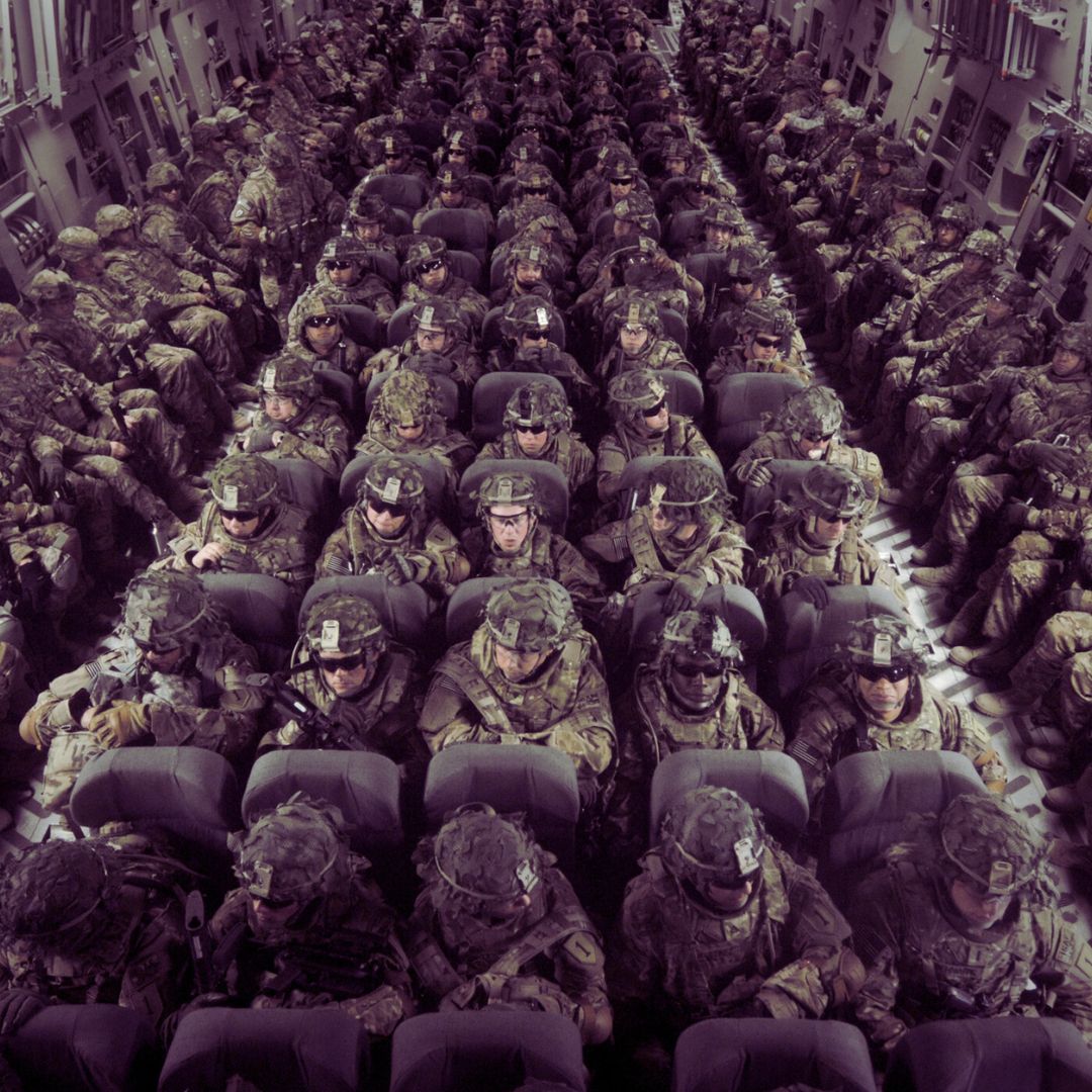 military members sitting in a cargo plane
