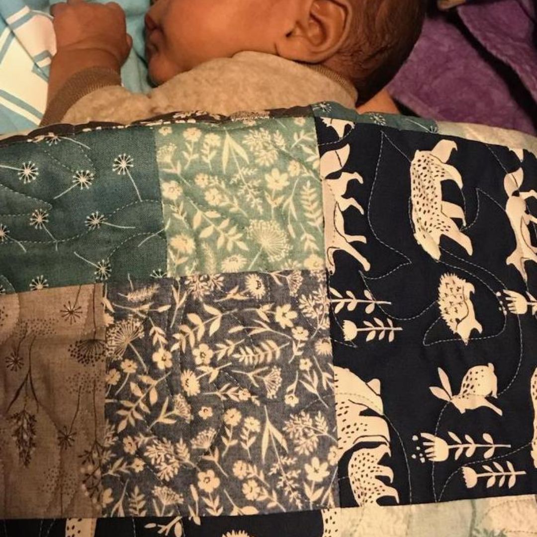 baby with quilt