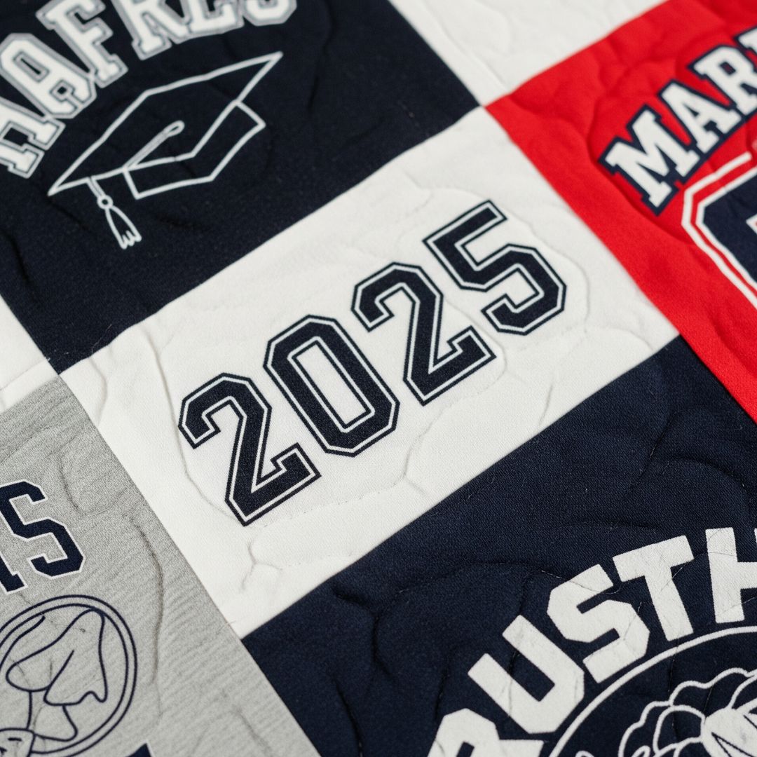 Close-up of a t-shirt quilt block with a graduation year, symbolizing preserved milestones. 