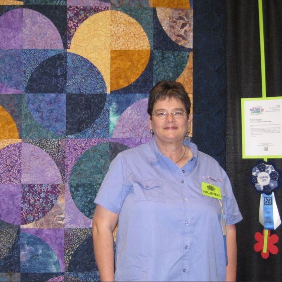 our quilter with a handmade quilt